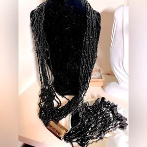 N320 Multi strand necklace of black beads, gold flake glass bead, bead tassel…